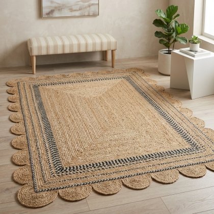 Scalloped jute rug with black and white trim